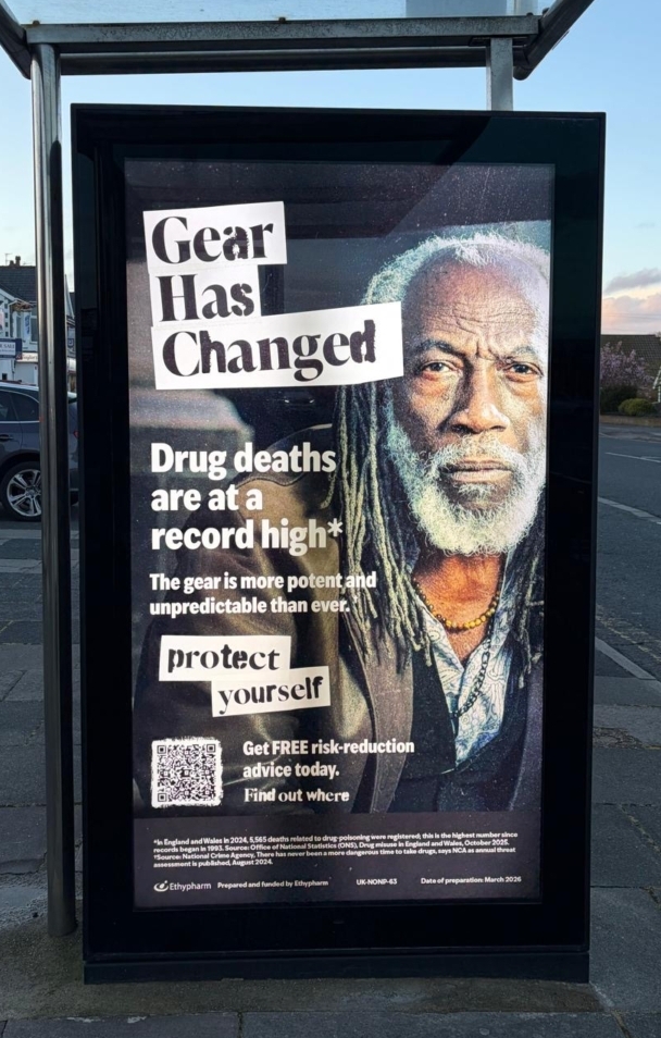 A poster on the street stating: "gear has changed: Drug deaths are at a record high".