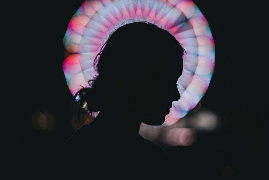 A woman standing in front of a kaleidoscope pattern.