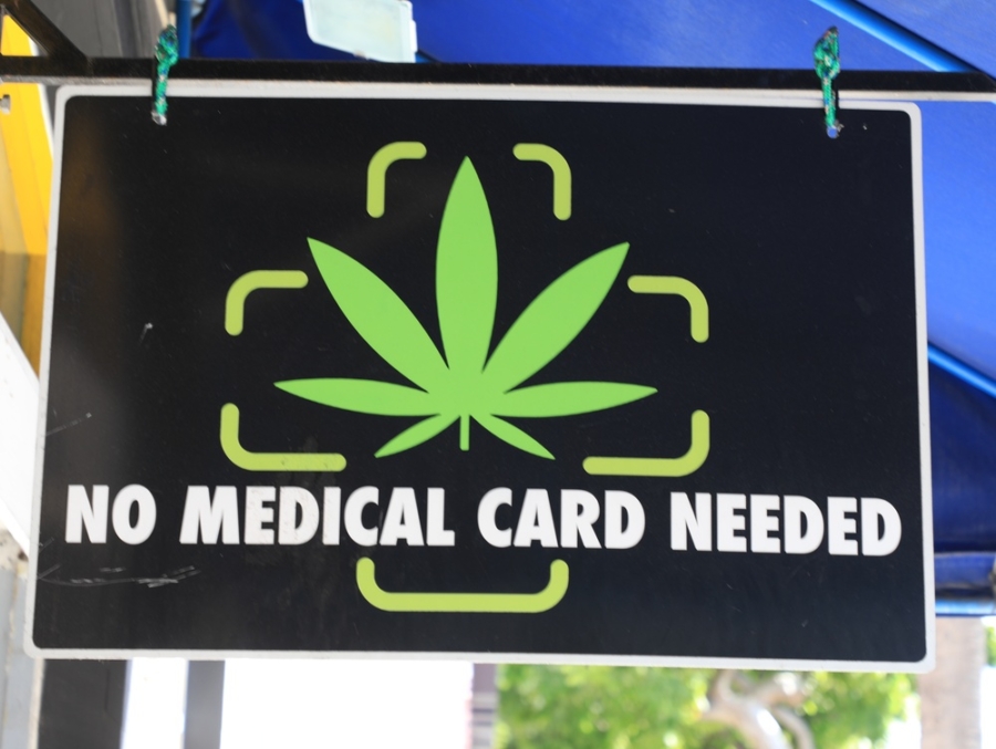 A cannabis dispensary sign reads "No Medical Card Required".